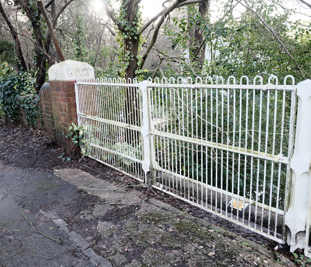 A metal driveway gate installation in progress in Pearland, TX